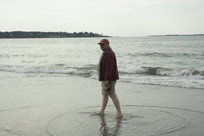 Mark walks along the shore