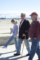 three walking beside the beach