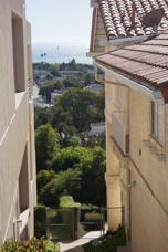 View of sea from between two houses