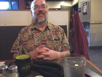 Mark at a restaurant table