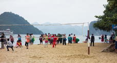 Beach with people and volleyball net