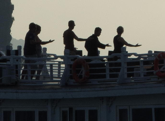 folks doing tai chi on a nearby vessel
