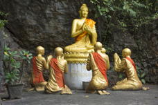 kneeling figures, surrounding a bepedestaled Buddha