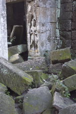 statue in niche, tumbled blocks in the foreground