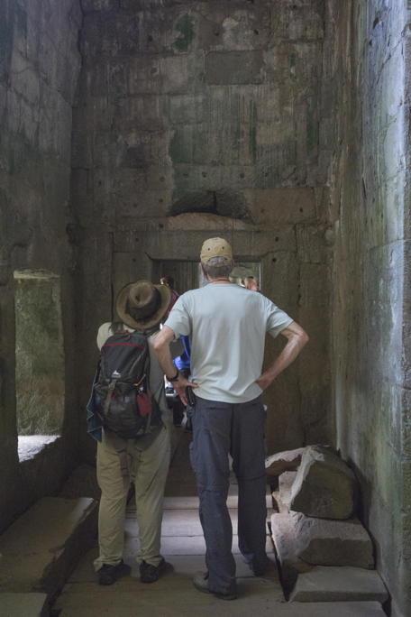 two men in a Ta Prohm gallery, one short, one tall