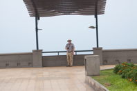 Mark stands in a pavilion by the sea