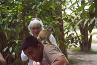 monkey crawling on teenager’s shoulder