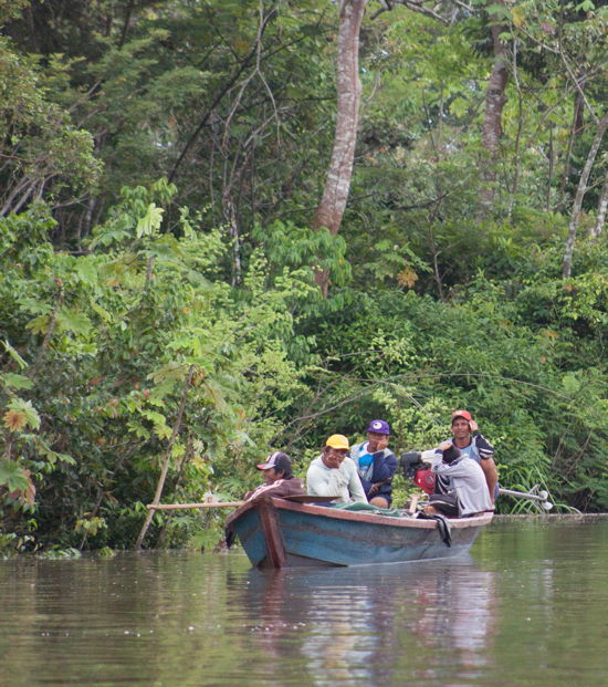 Several local men on a low-riding boat