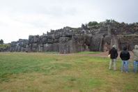 Figures in foreground, monoliths in background