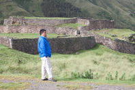 Rubén standing in front of walls