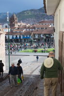 Mark walks down a street towards the Plaza