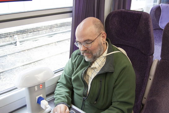 MTK sitting on first class seat in train