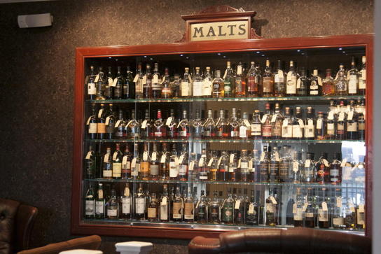 Huge cabinet filled with bottles of whisky